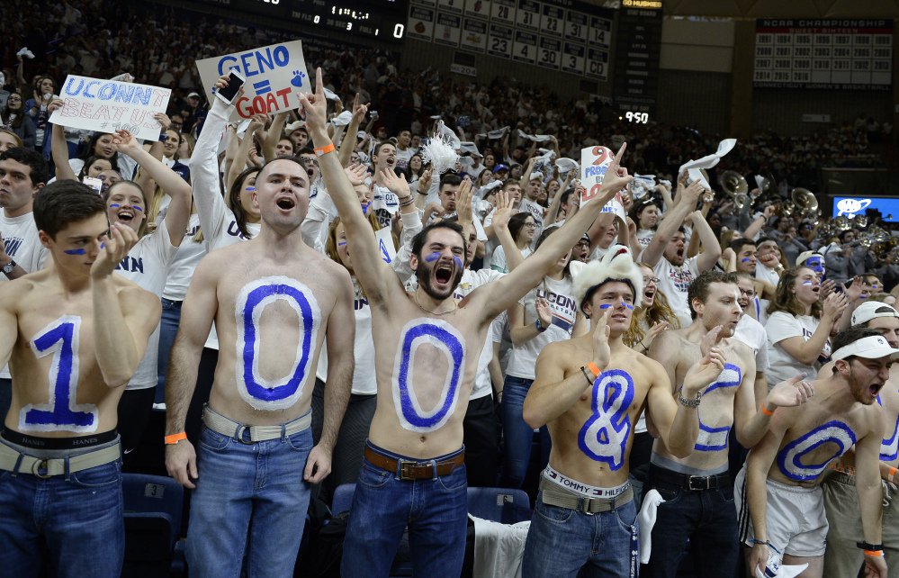 UConn students cheer as the team is introduced before Monday night's game. At the end of Connecticut's 100th straight win, fake hundred dollar bills dropped from the ceiling of the arena.