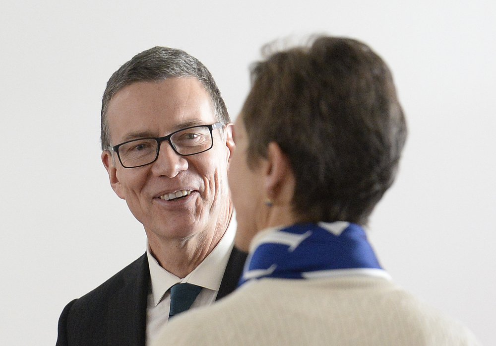 UNE's next president, Dr. James Herbert, speaks with presidential search committee Chairwoman Gloria Pinza before the start of a news conference Tuesday.