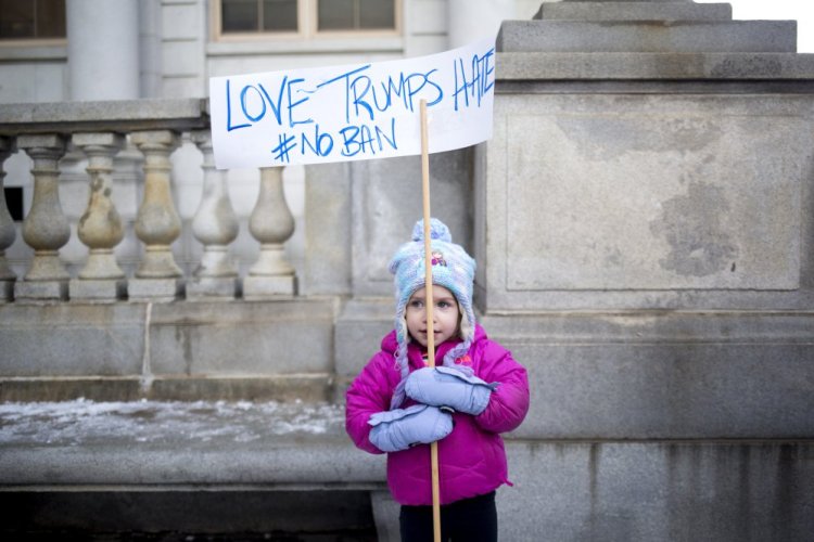 Kaye Harrington, 3, attends a rally against the president's travel ban. Her mom, Sarah Harrington, told her they were going to show their Muslim friends that we love them.