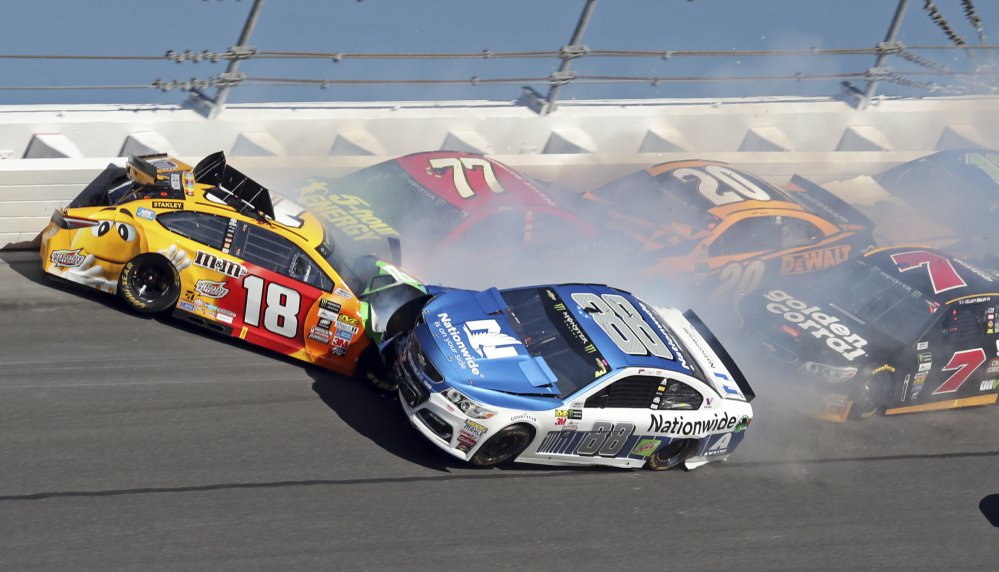 Dale Earnhardt Jr., 88, hits Kyle Busch, 18, along with Erik Jones, 77, Matt Kenseth, 20, and Elliott Sadler, 7, during the Daytona 500 Sunday at Daytona International Speedway in Daytona Beach, Fla.