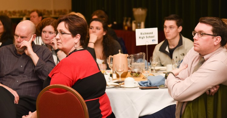 Students and staff members from Richmond Middle/High School listen to Emilie van Eeghen, vice president of behavioral health services at MaineGeneral Health, giving a speech on the opiate epidemic in central Maine at the United Way of Kennebec Valley's annual meeting. The students were recognized for their participation in the United Way's Day of Caring.