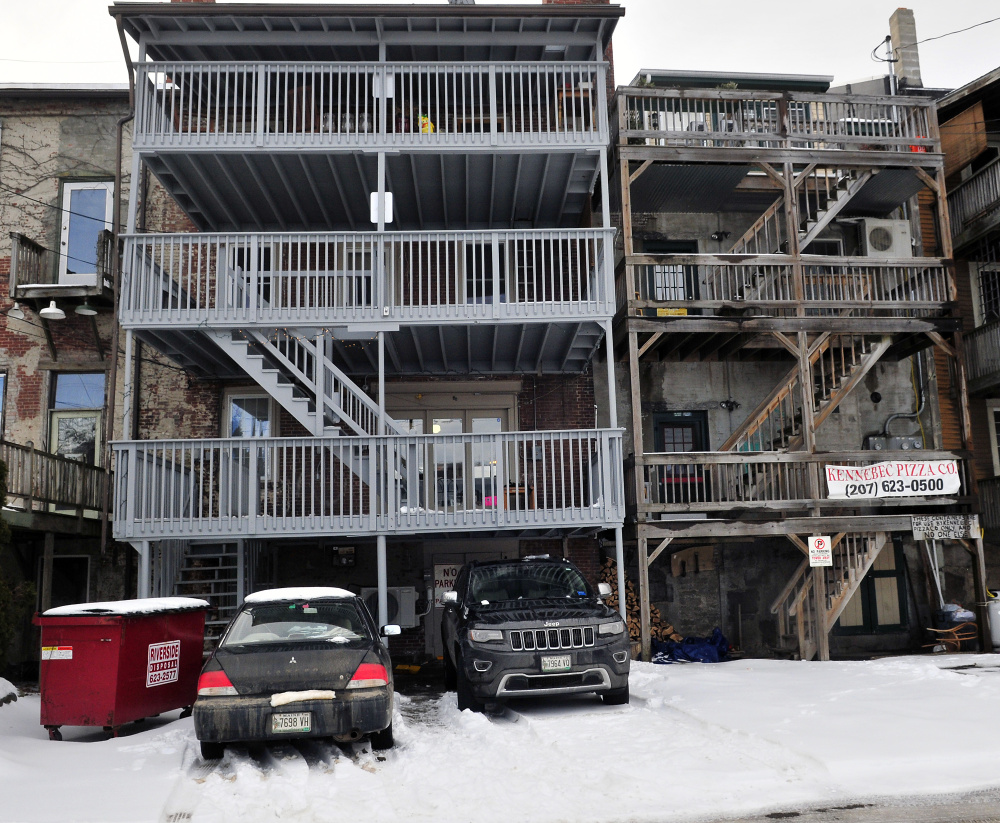 Tenants at 150 Water St. in downtown Hallowell have reserved parking spots, as seen Wednesday. Most of the buildings on the east side of Water Street have parking spots between the buildings and the Kennebec River.