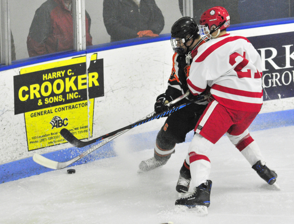 Gardiner's Joe Clark, left, and Cony/Monmouth/Hall-Dale's Thomas Arps battle for a puck during a game Friday at the Camden National Bank Ice Vault in Hallowell.