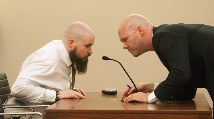 Leroy Smith III, left, confers with defense attorney Scott Hess in January during a hearing on Smith's mental competence to be tried for murder, in connection with the slaying and dismembering of his father in May 2014.