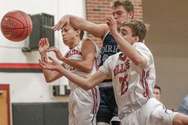 Dirigo junior Cooper Chiasson goes up to the rim as Hall-Dale's Ashtyn Abbott, right, and Austin Stebbins defend during a Class C South prelim game Thursday night.