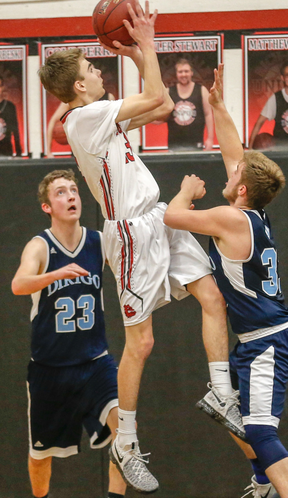 Hall Dale's Ashtyn Abbott goes up for a shot in between Dirigo defenders Cooper Chiasson and Chase Clark during a Class C South prelim game Thursday night.