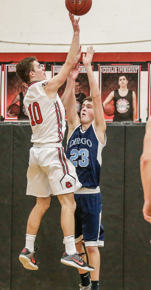 Hall-Dale's Alec Byron goes up for a shot as Dirigo's Chase Clark defends during a Class C South prelim game Thursday night in Farmingdale.