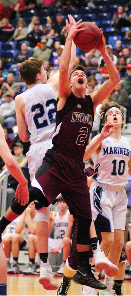 Nokomis' Joshua Smestad and Oceanside's Cooper Wirkala go for a rebound during a Class A North quarterfinal game Saturday at the Augusta Civic Center.