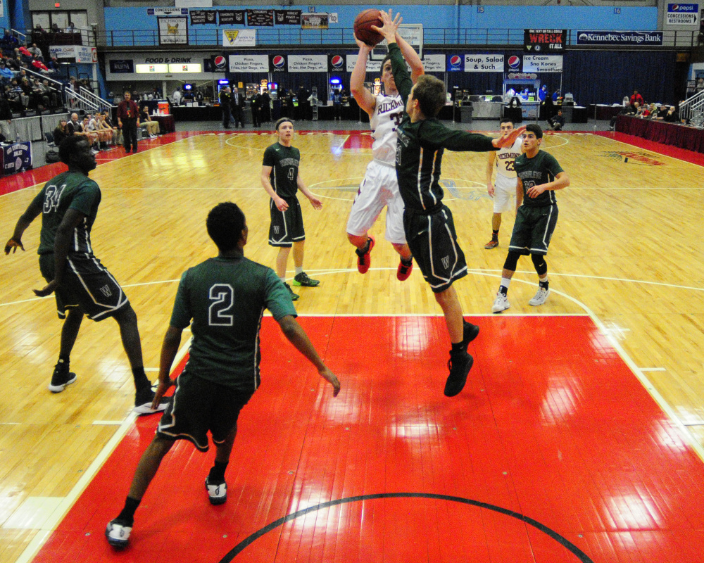 Richmond's Matt Holt, bottom, shoots as Waynflete's Christian Brooks tries to block the shot during a Class C South quarterfinal game Monday  at the Augusta Civic Center.