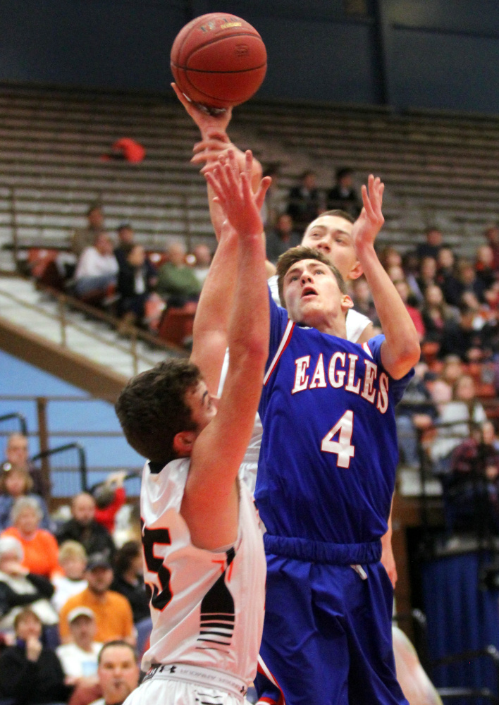 Messalonskee's James Kouletsis puts up a shot over Gardiner defender Cole Heaberlin, bottom left, and Isaiah Magee last Saturday at the Augusta Civic Center.