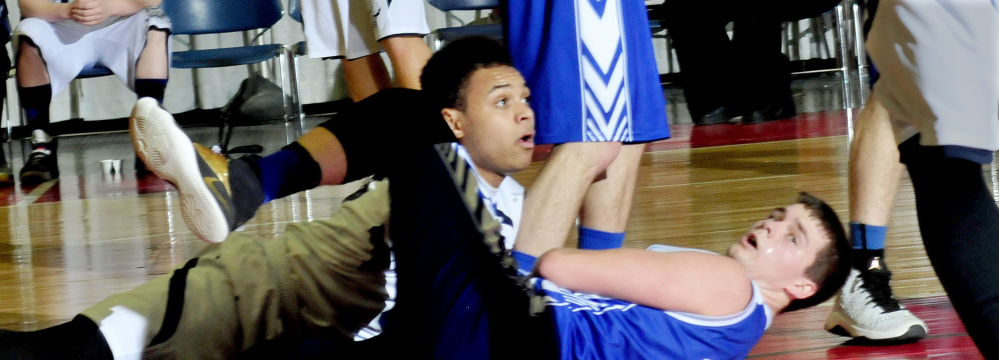 A.R. Gould's Tyrese Collins, left, and Valley's Dillon Beane look up at referee for the call after they collided and fell during a Class D South semifinal Wednesday at the Augusta Civic Center.