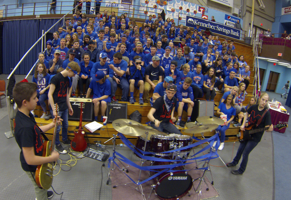 Messalonskee pep band members Jared Handley, left, Heather Doucette and Will McPherson play during the Class A North championship game Friday at the Augusta Civic Center. Ian Cates is the fourth member of the rock and roll quartet that plays songs such as "Smells Like Teen Spirit" and "Seven Nation Army" during games.