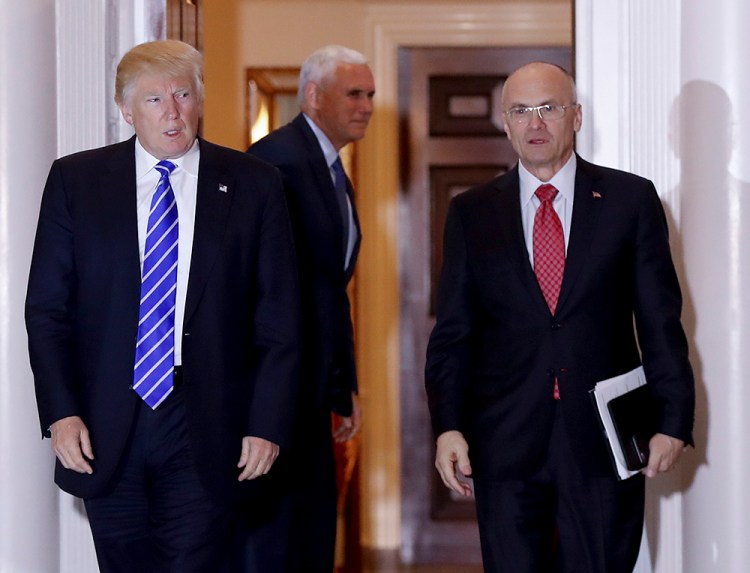 Then-President-elect Donald Trump walks with Labor Secretary-designate Andy Puzder from the Trump National Golf Club Bedminster clubhouse in Bedminster, N.J., on Nov. 19, 2016.