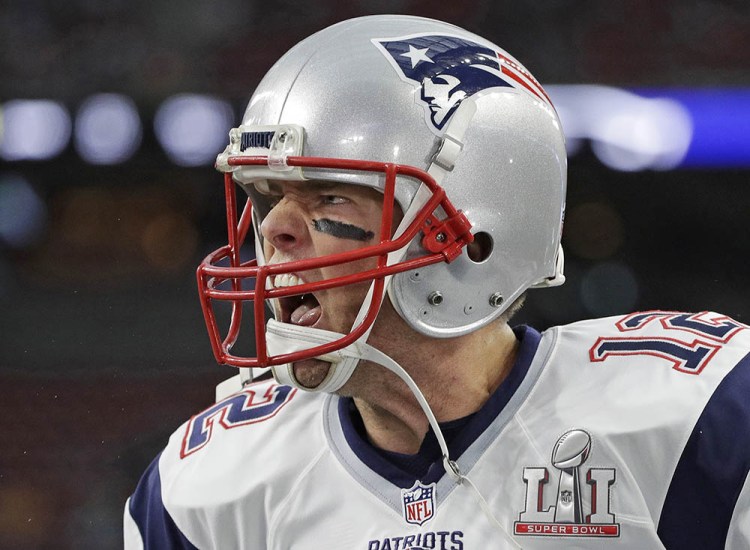 New England Patriots' Tom Brady runs onto the field before the team's Feb. 5 Super Bowl game against the Atlanta Falcons in Houston. A new book and a movie are in the works about Brady and the suspension he overcame to earn an unprecedented fifth Super Bowl ring. 