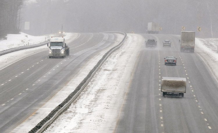 Motorists make their way along the Maine Turnpike in Arundel on Tuesday. Snow was expected to continue all day and turn into a wintry mix tonight. 