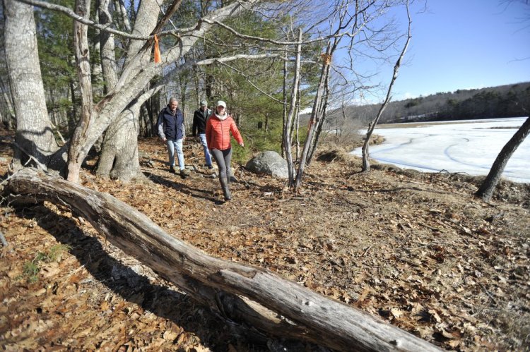 From left: Archie Bonyun, Dennis Dunbar and Anna Christie-Carnicella of the Kennebec Estuary Land Trust walk through Squam Creek Preserve on Westport Island Thursday (Staff photo by Shawn Patrick Ouellette)