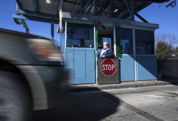 Denise Blanchette of Lewiston collects toll money Thursday at Maine Turnpike Exit 48 in Westbrook. Gov. Paul LePage would like to eliminate almost all of the state's tollbooths and have one only in Kittery to collect money from out-of-state drivers entering the state.