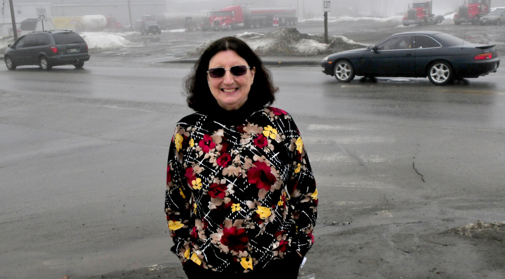 Regional School Unit 18 school health coordinator and grant writer Claire Heffernan stands Wednesday at the intersection of busy Heath and Oak streets in Oakland, where new sidewalks, a crosswalk and lights will be installed for student safety.
