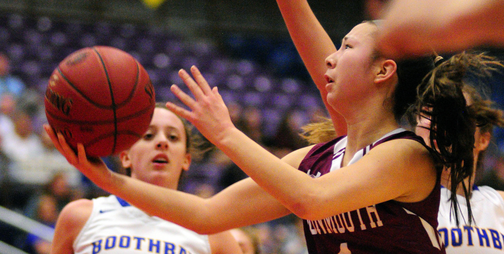 Monmouth's Tia Day, right, goes in for a shot against Boothbay during a Class C semifinal game last Thursday at the Augusta Civic Center.