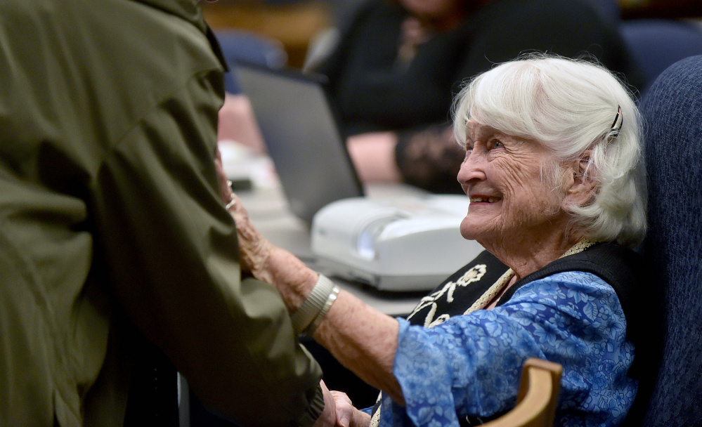 Hope Wing Weston, daughter of Eugene Wing, greets history buffs Wednesday before a presentation about her father at the Lawrence Junior High School library in Fairfield.