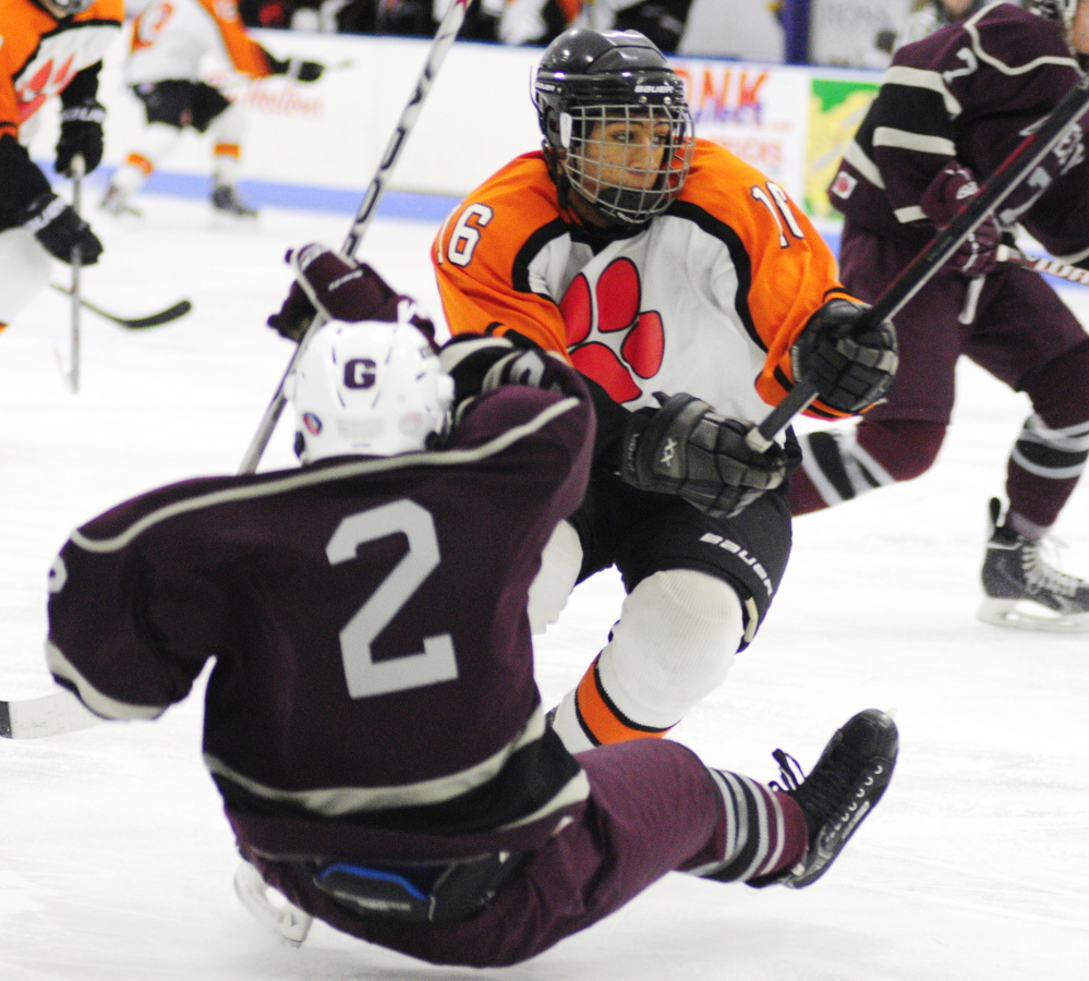 Gardiner defender Hunter Russell, top, gets past Greely forward Quinn Malloy during a 2015 game at the Camden National Bank Ice Vault in Hallowell.