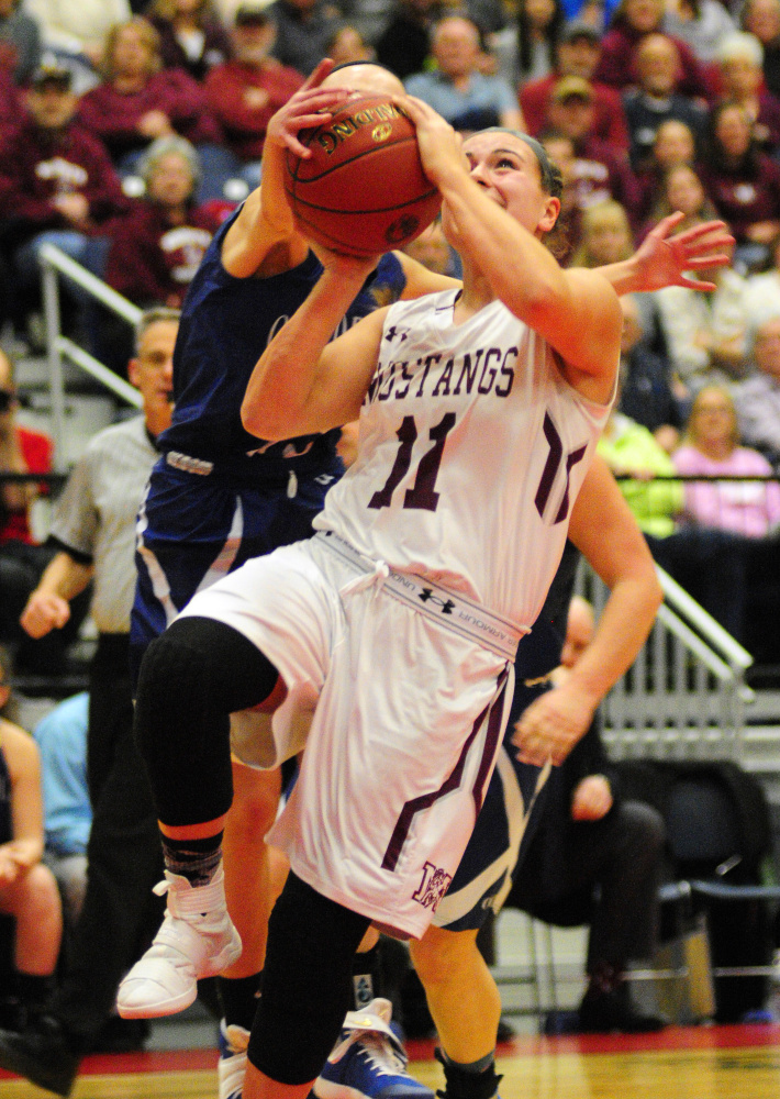 Old Orchard's Brianna Plante, left, blocks Monmouth's Hannah Anderson during the Class C South championship game last at the Augusta Civic Center.