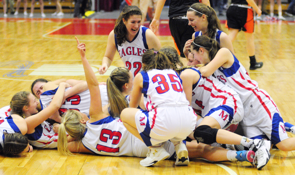 Messalonskee players celebrate at mid-court after beating Brunswick in the Class A state final Saturday at the Augusta Civic Center.