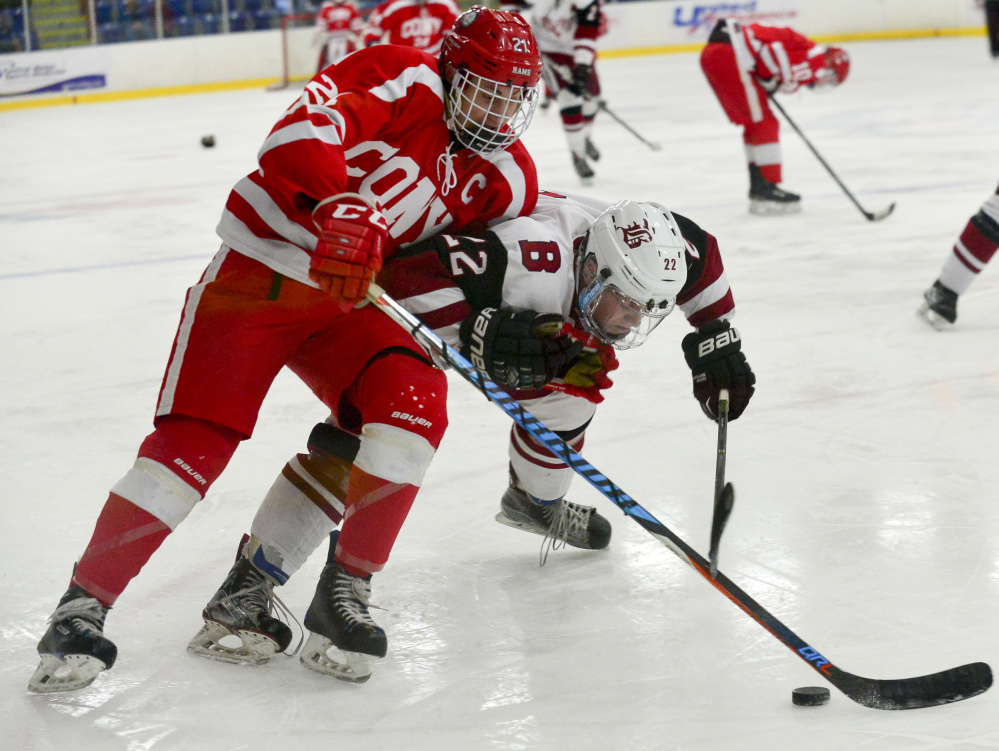 Bangor's Kodi Lagassie, right, smashes into Cony's Thomas Arps in an attempt to gain control of the puck in the second period of the Class A North semifinals Saturday at the Androscoggin Bank Colisee in Lewiston. Bangor went on to win 2-1.