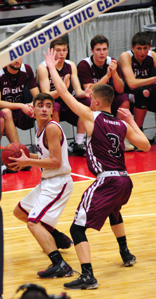 Messalonskee's Chase Warren gets covered by Greely's Jordan Bagshaw in Class A state final Saturday at the Augusta Civic Center.