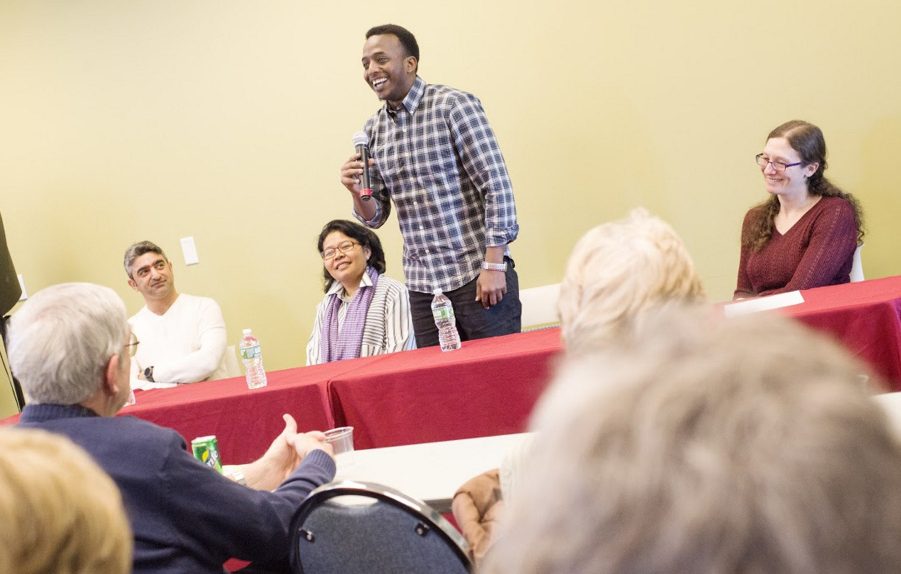 Somali immigrant Abdi Iftin speaks about learning English from Arnold Schwarzenegger movies and misconceptions he had about the United States before arriving 2   years ago during a panel discussion with Iraqi refugee Nawar Al Obaidi, left, and Cambodian refugee Makara Meng, second from left, led by the Holocaust and Human Rights Center of Maine Executive Director Elizabeth Helitzer, right, Monday in Augusta.