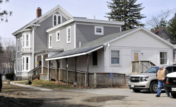 Fire marshal's investigator Ken MacMaster prepares to re-enter 73 Pleasant St. in Waterville while investigating a fire that occurred early on April 3, 2016. Residents at the home run by Motivational Services Inc. were relocated temporarily.