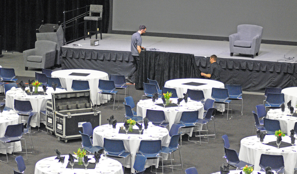 Headlight Audio Visual employees set up a large television monitor on Tuesday, so that speakers on stage can see what is on the big screens behind them, for the The Governor's Conference on Tourism in the Augusta Civic during a nor'easter storm in Augusta.