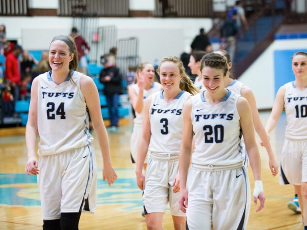 Cony graduate Josie Lee (20) walks off the floor with fellow members of the Tufts University women's basketball team