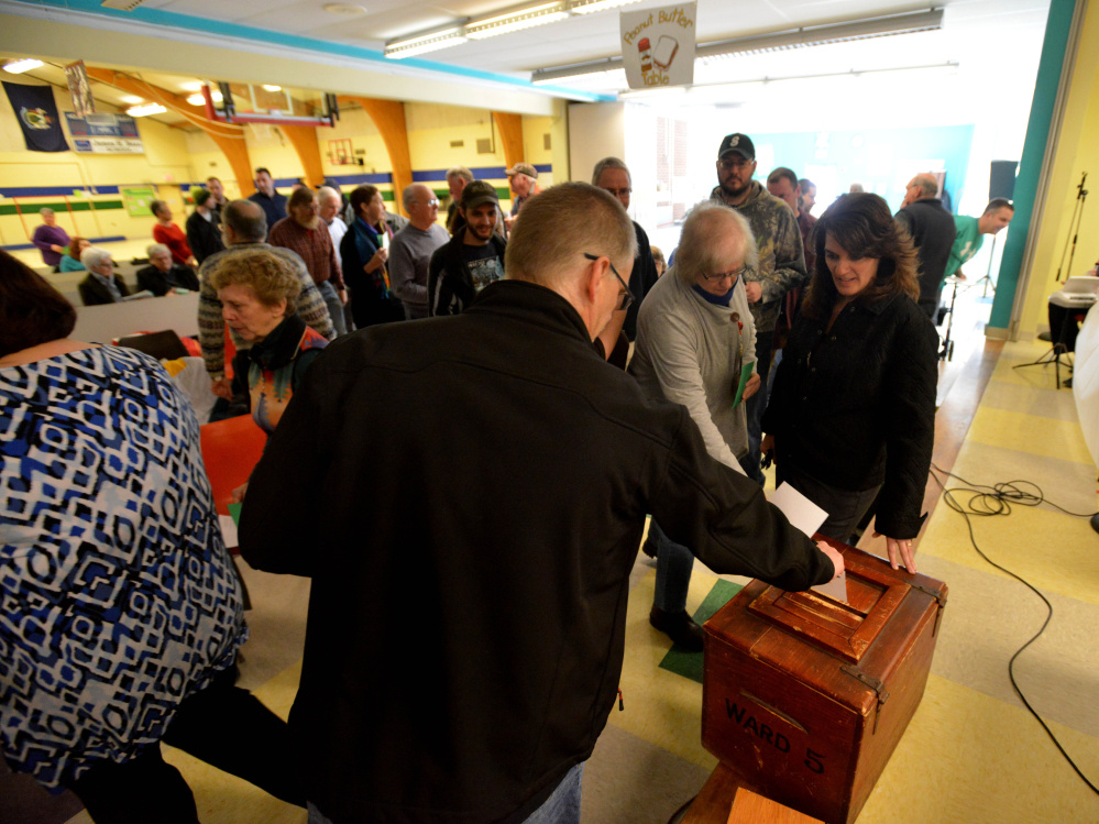 Sidney residents deposit their secret ballots for Budget Committee members Saturday during Town Meeting at James H. Bean School.