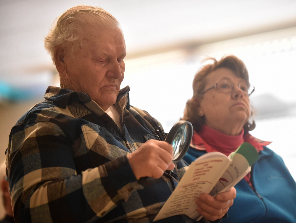 Larry Tibbetts reads the meeting budget Saturday during Town Meeting at James H. Bean School in Sidney.