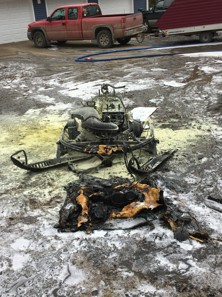 This snowmobile was destroyed Friday morning after bursting into flames in a garage off China Road in Winslow.