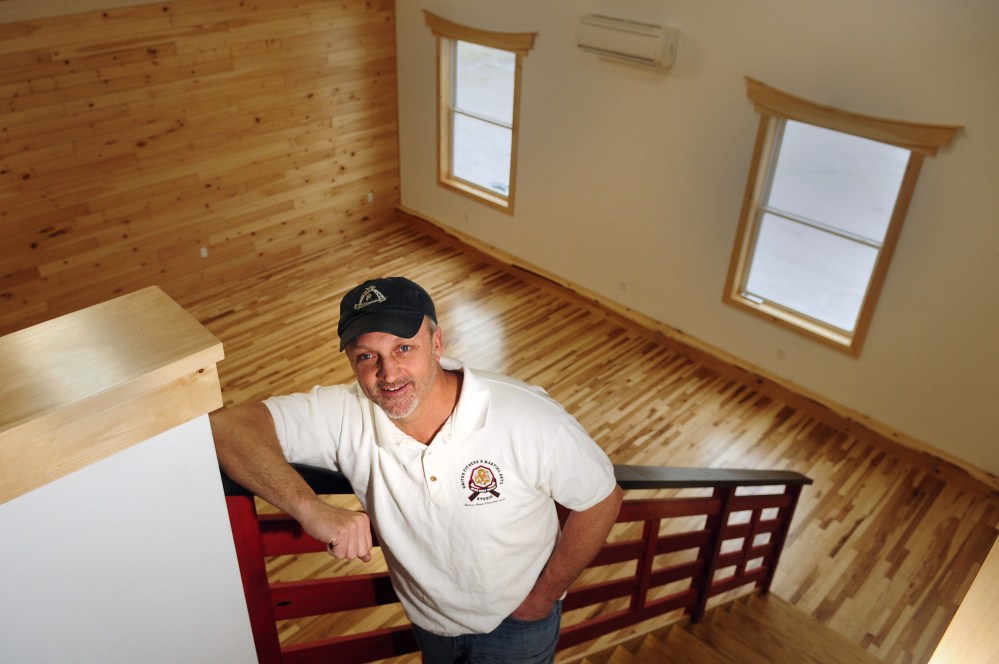 Ryan Chamberland, owner of United Fitness and Martial Arts Studio, talks about expansion plans Friday in a recently renovated room of his Winthrop business.