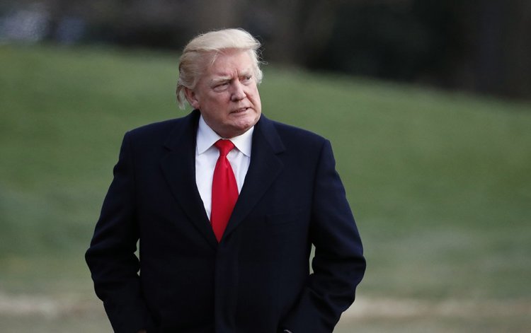 President Trump walks to the White House after arriving on Marine One, Sunday after a weekend at his Mar-a-Lago estate in Palm Beach, Fla. 