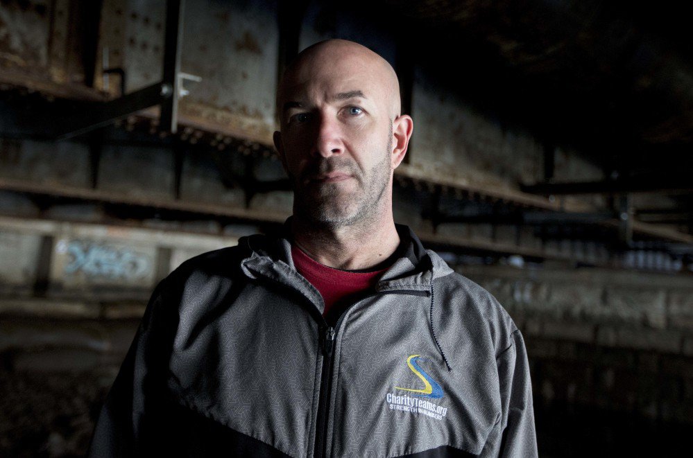 Danny Dwyer poses last month under the bridge where he used to sleep when he was homeless in Boston. Dwyer, 50, plans to run in the Boston Marathon on April 17. It's the latest step away from his former battles with drug addiction, job loss and four years living under the bridge.