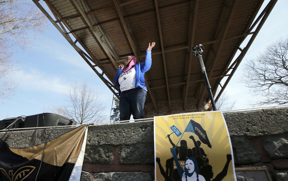 Organizer Samaa Abdurraqib speaks at Deering Oaks in Portland on Saturday during a rally in support of immigrants. An earlier rally at Portland City Hall drew a crowd of about 300 people.