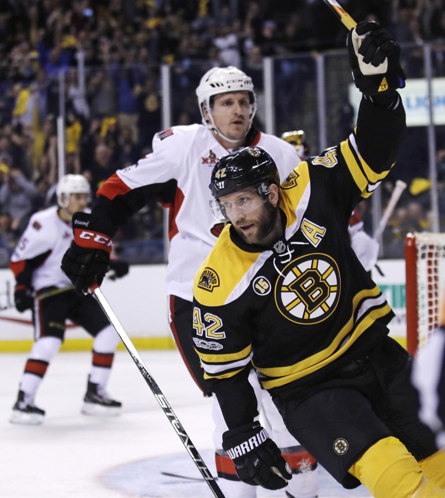 Boston center David Backes (42) celebrates after scoring on Ottawa goalie Craig Anderson (41) in the second period.