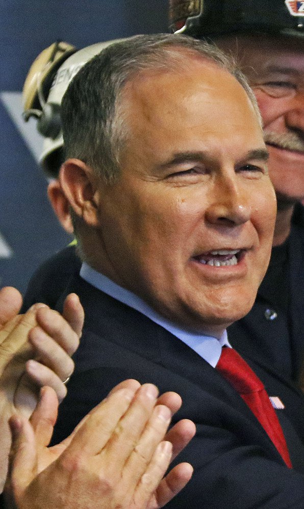U.S. Environmental Protection Agency Administrator Scott Pruitt holds up a hardhat he was given during a visit to Consol Pennsylvania Coal Company's Harvey Mine in Sycamore, Pa., Thursday, April 13, 2017. (AP Photo/Gene J. Puskar)