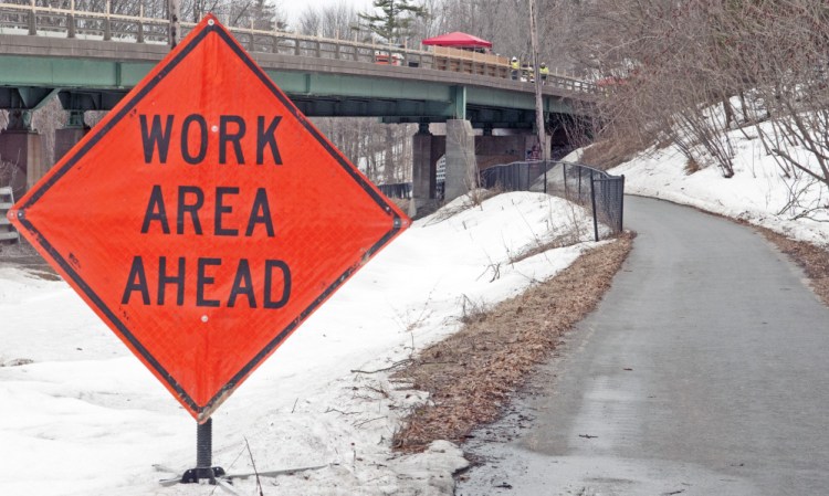 Work is going on above and below Water Street, as seen from the Kennebec River Rail Trail on Tuesday, at Millikens Crossing Bridge in Hallowell.
