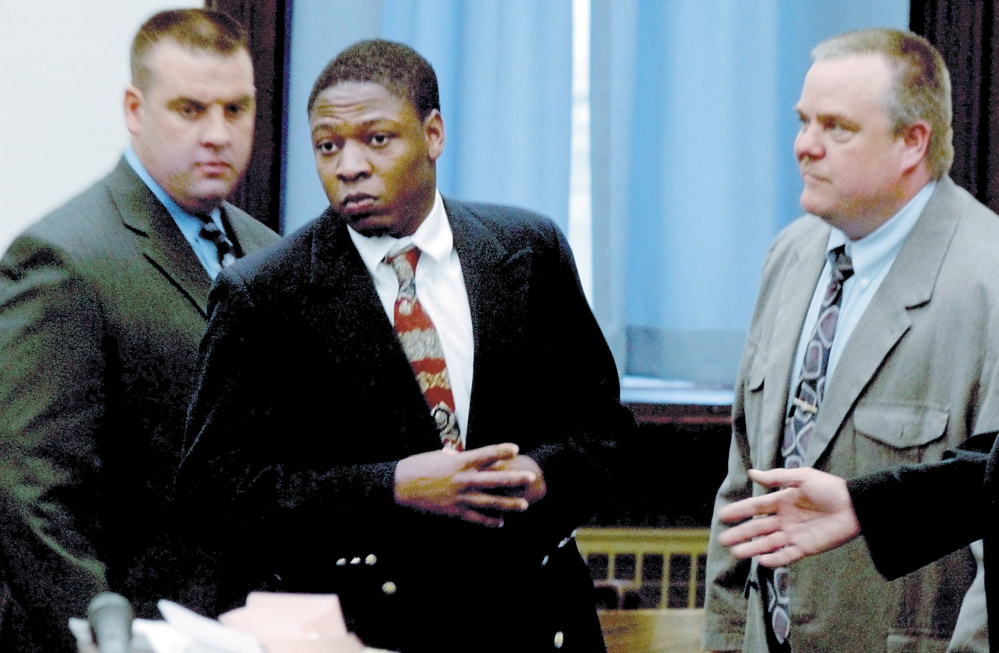Daniel L. Fortune, center, is escorted by deputies into the Somerset County Superior Court in Skowhegan during his trial.