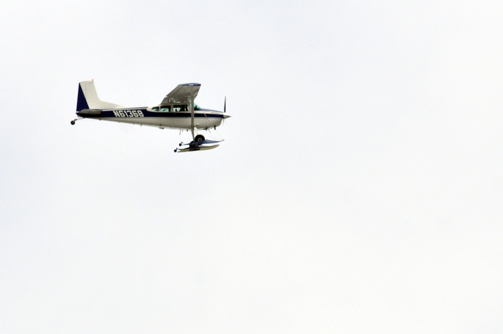 A Maine Warden Service plane circles over Western Avenue near exit 109 on Interstate 95 in Augusta around 11 a.m. on Saturday as part of a search to locate a cellphone caller.