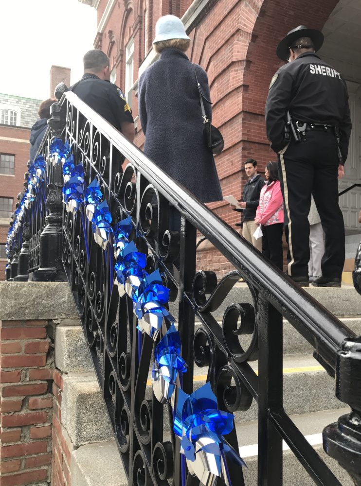 Waterville Mayor Nick Isgro reads a proclamation and speaks to about a dozen people who turned out Wednesday evening on the steps of Waterville City Hall to mark Child Abuse & Neglect Prevention Month.