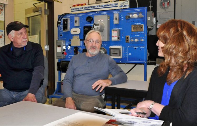 Officials say the solar design program at Kennebec Valley Community College in Fairfield is thriving. Speaking in front of a photovoltaic system are instructors Keven Vachon, left, Rich Roughgarden and Program Coordinator Robin Weeks on Thursday.