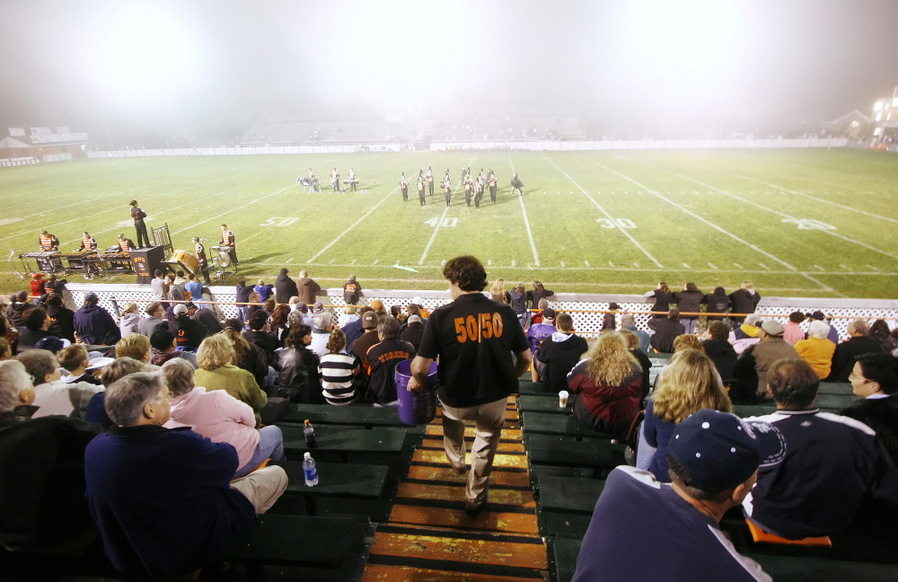 In this 2007 file photo, Don Houde sells raffle tickets in the bleachers during halftime of a game at Waterhouse Field in Biddeford. It was announced last week that field will not host the annual Lobster Bowl Classic and will be closed for the upcoming football season after an independent study showed the bleachers were too dangerous to sit in.