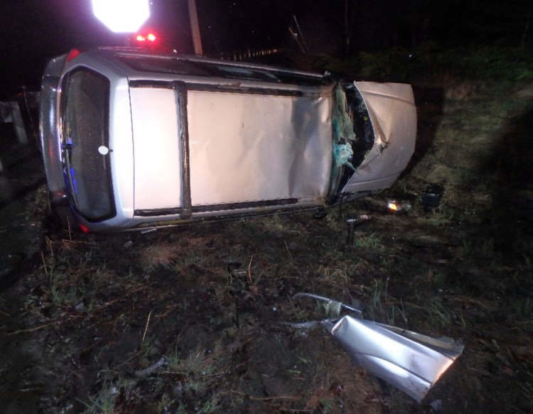 A 2004 Subaru Forester rests on its side after crashing into a guardrail and rolling over on Carter Memorial Drive in Winslow on Saturday morning. A China man who allegedly walked away from the wreck has been charged with three offenses.