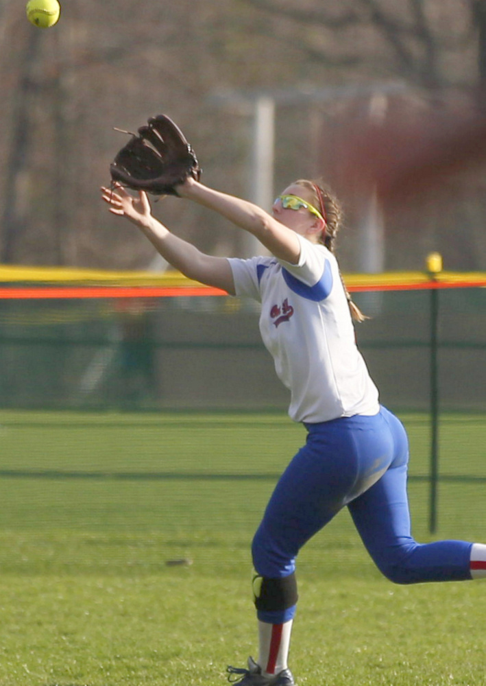 Oak Hill outfielder Charlotte Waterman tracks down a fly ball for the final out of an inning on Monday against Monmouth.